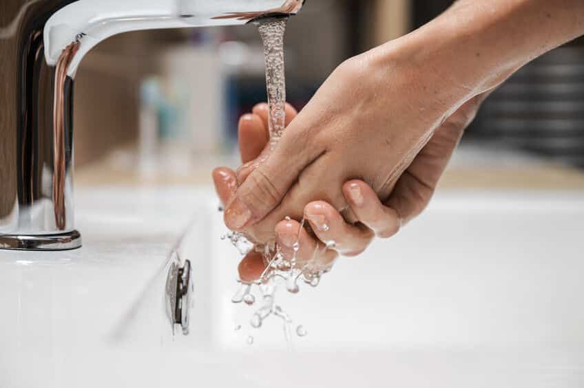 Woman washing her hands with soft water thanks to having a water softener installed